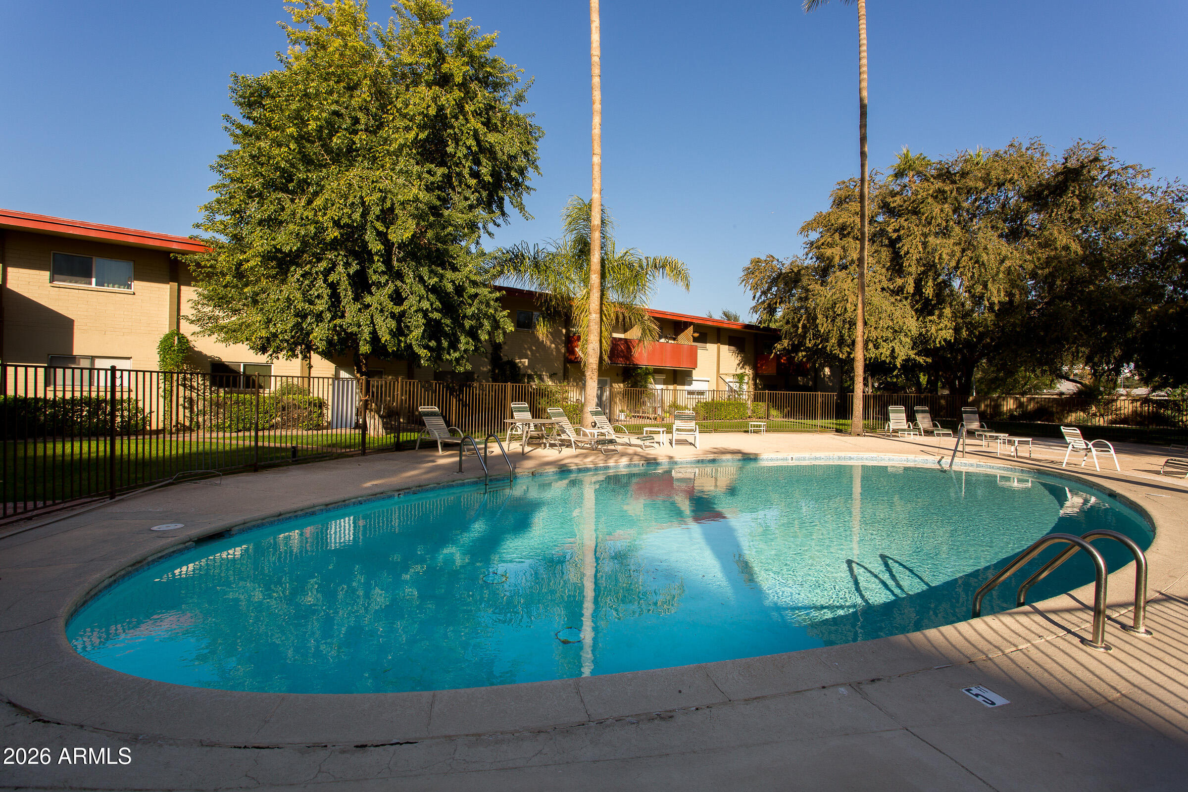 353 East Thomas Road, Unit C501 Phoenix, AZ 85004 - Photo 14 of 53 a view of a swimming pool with a patio