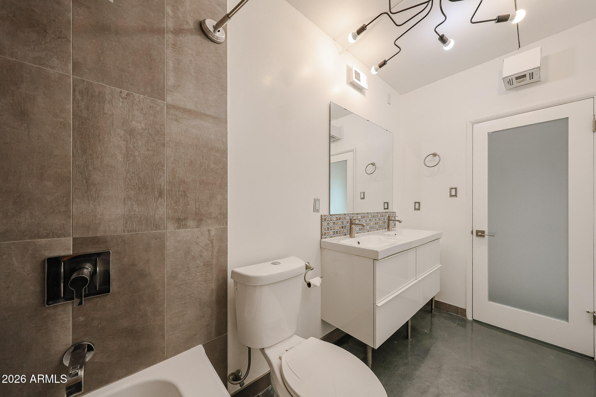 353 East Thomas Road, Unit C501 Phoenix, AZ 85004 - Photo 35 of 53 a bathroom with a sink a toilet and mirror