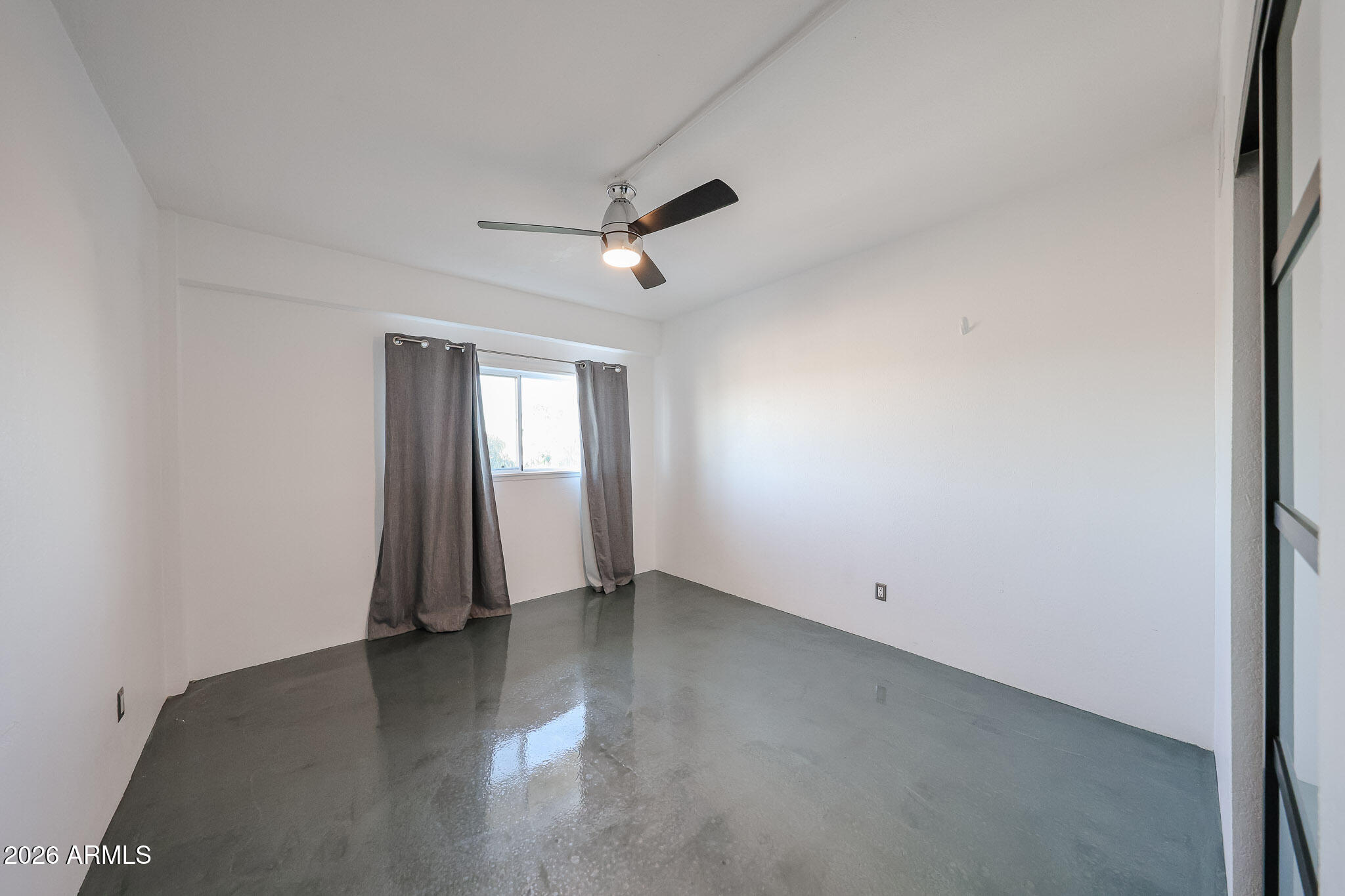 353 East Thomas Road, Unit C501 Phoenix, AZ 85004 - Photo 36 of 53 an empty room with wooden floor and windows