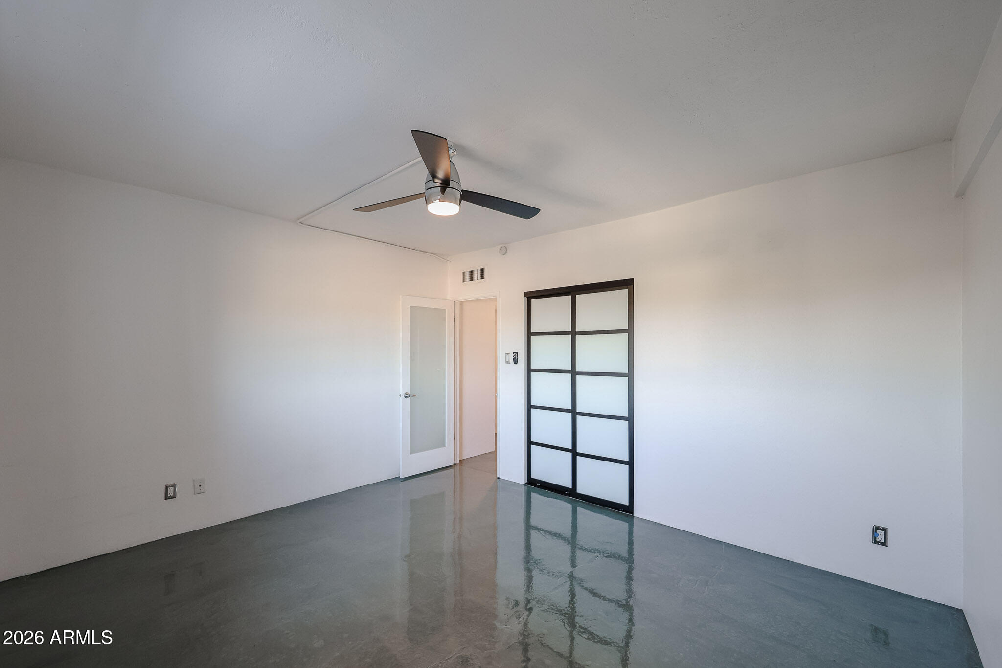 353 East Thomas Road, Unit C501 Phoenix, AZ 85004 - Photo 43 of 53 an empty room with windows and ceiling fan
