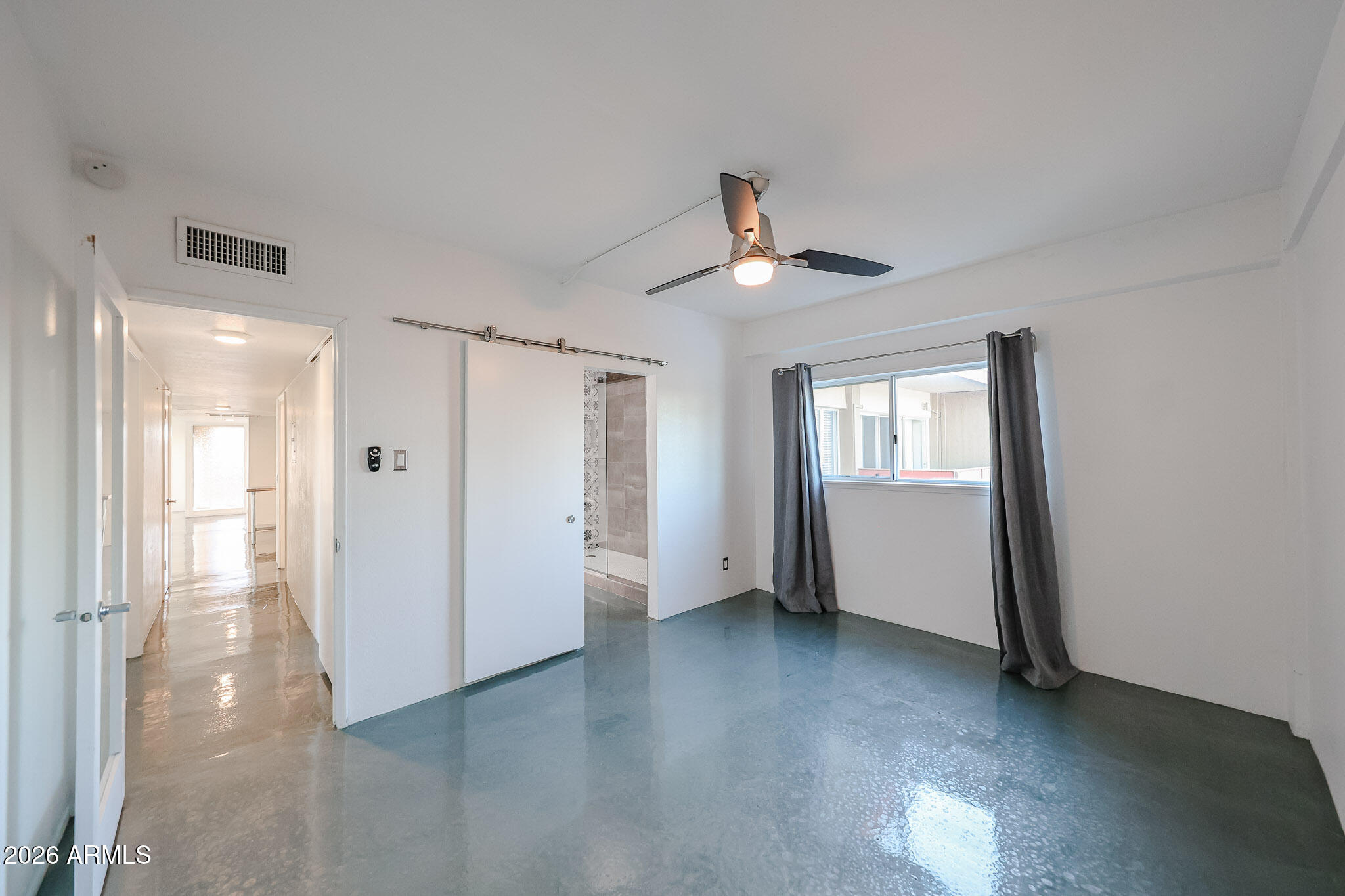 353 East Thomas Road, Unit C501 Phoenix, AZ 85004 - Photo 46 of 53 a view of a livingroom with a ceiling fan and window