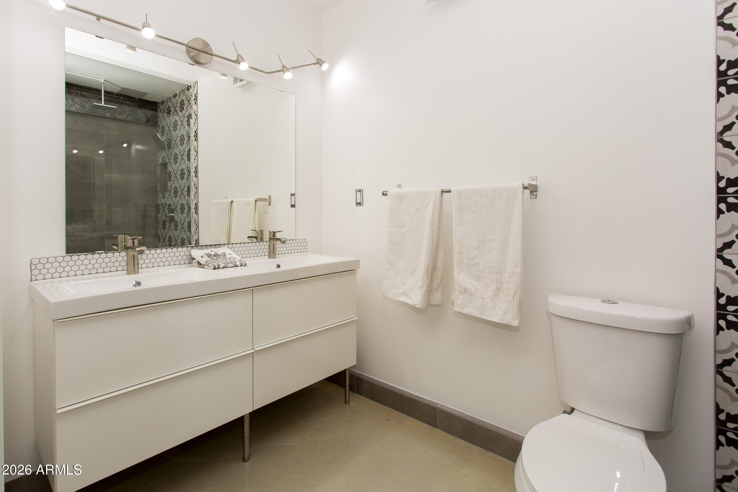 353 East Thomas Road, Unit C501 Phoenix, AZ 85004 - Photo 9 of 53 a bathroom with a sink vanity mirror and toilet
