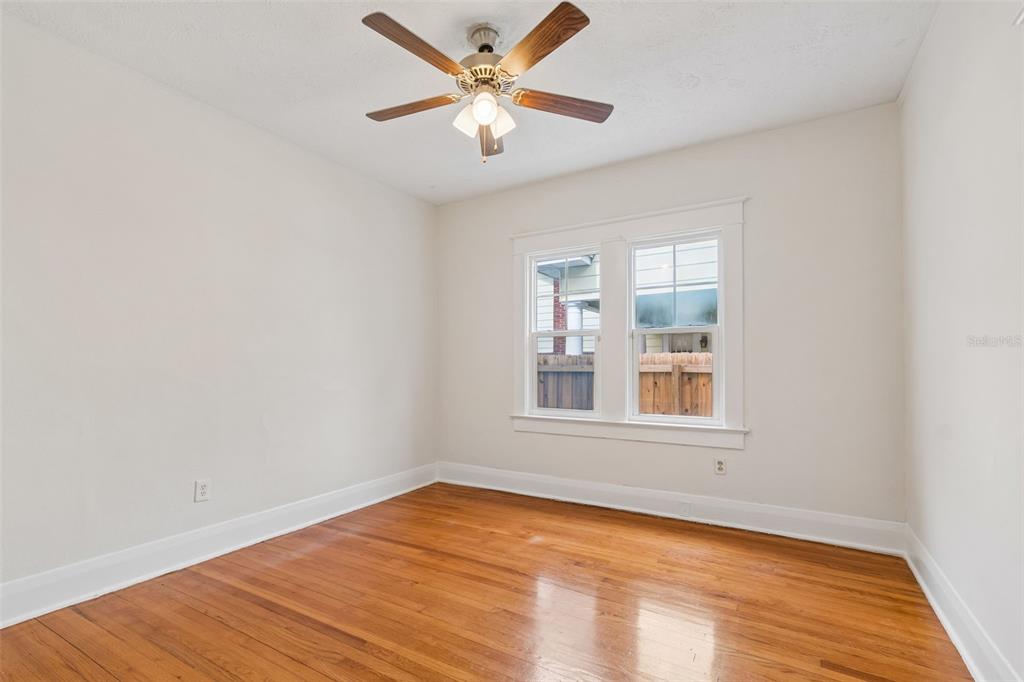 2434 West Prospect Road Tampa, FL 33629 - Photo 19 of 45 an empty room with wooden floor and windows