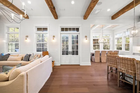 a room with wooden floor and windows