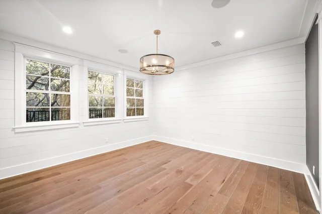 a view of a kitchen with furniture and wooden floor