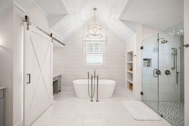 a bathroom with a granite countertop sink a toilet a mirror and shower