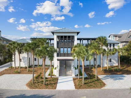 a view of a house with swimming pool and a yard