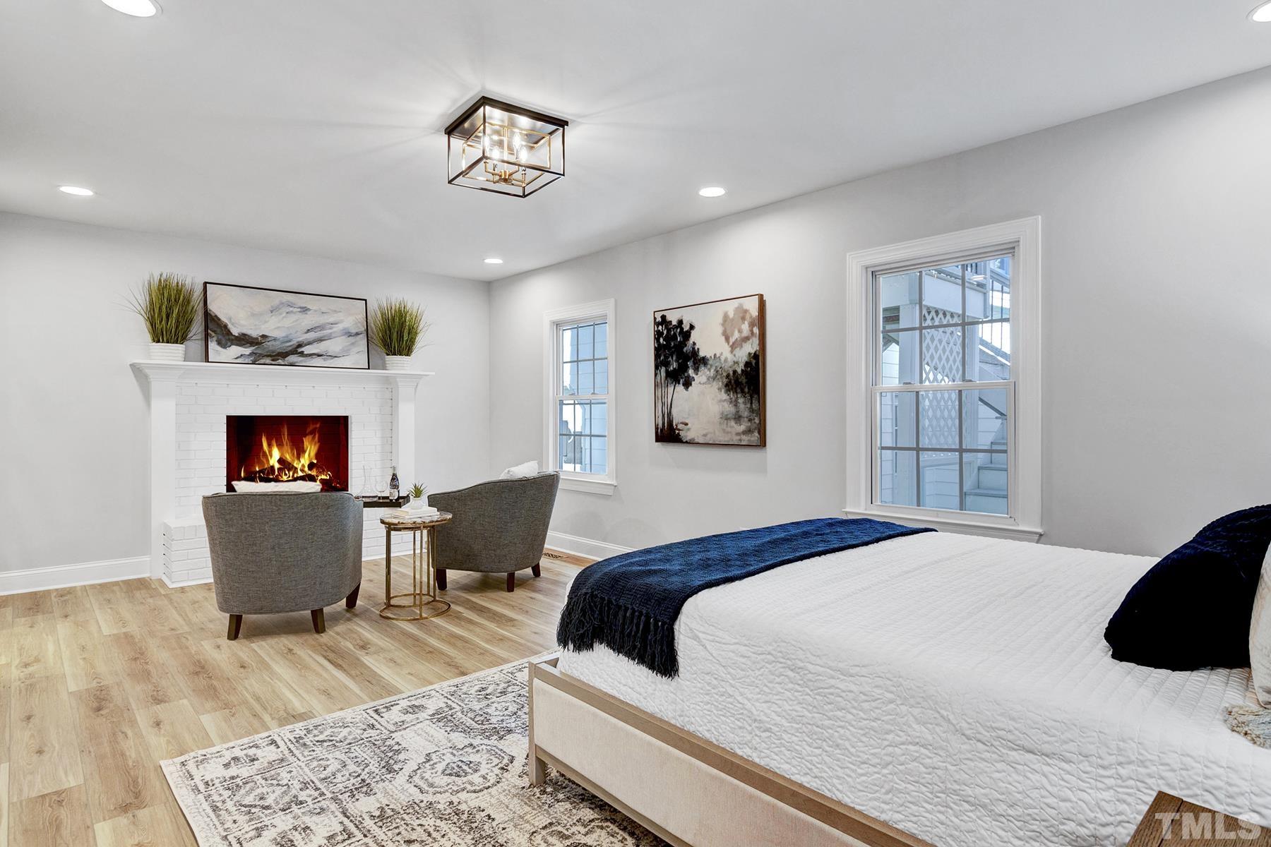 305 Windel Drive Raleigh, NC 27609 - Photo 23 of 39 a bedroom with a bed and a chair
