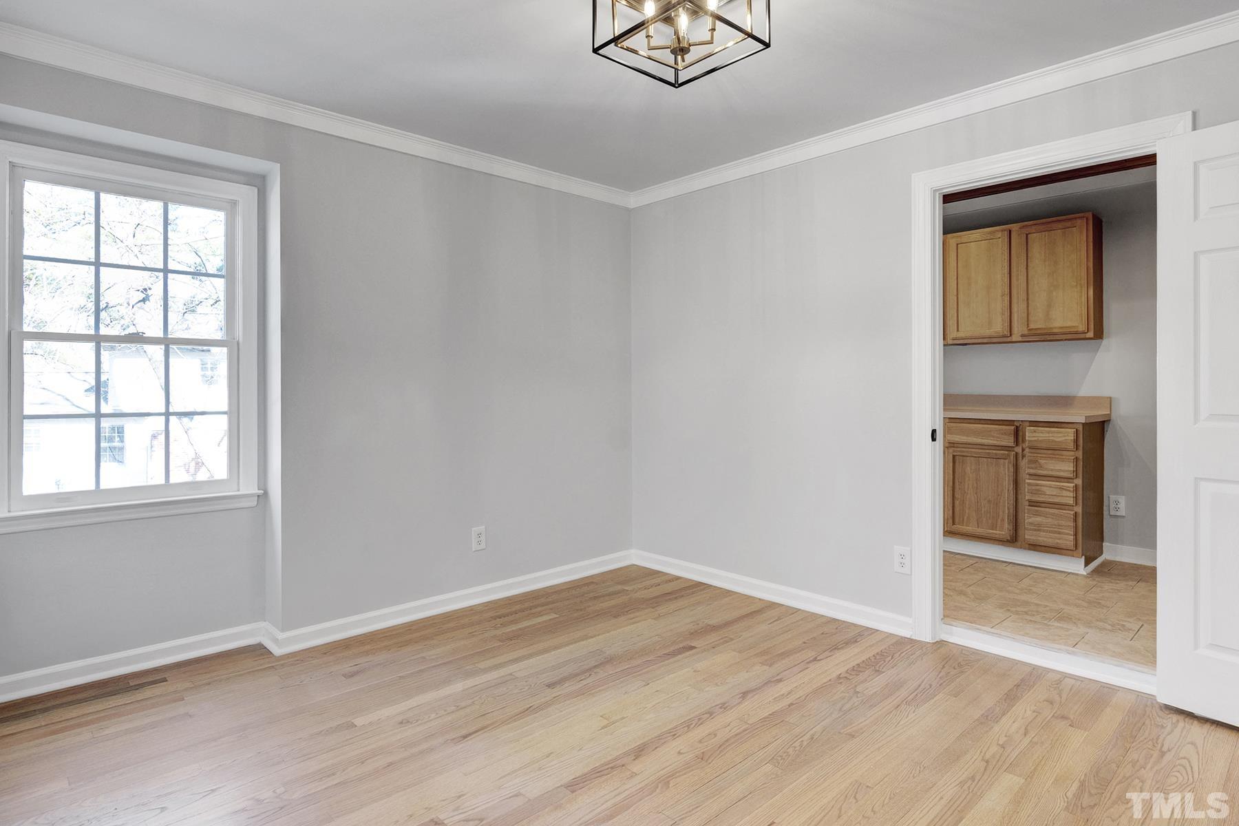 305 Windel Drive Raleigh, NC 27609 - Photo 28 of 39 a view of empty room with wooden floor and window