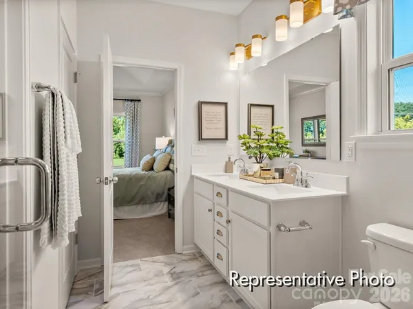 a en suite bathroom with a sink double vanity and a mirror