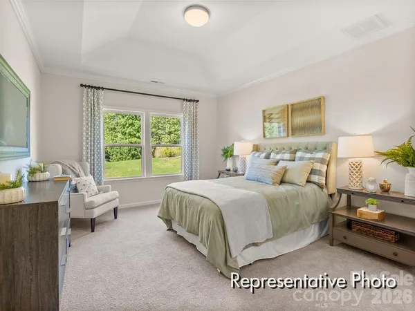 a spacious bedroom with a bed and a couch