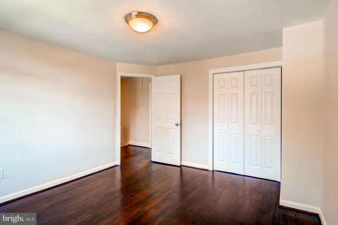 3821 Kimble Road Baltimore, MD 21218 - Photo 20 of 29 an empty room with wooden floor and windows
