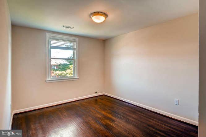 3821 Kimble Road Baltimore, MD 21218 - Photo 21 of 29 an empty room with wooden floor and windows