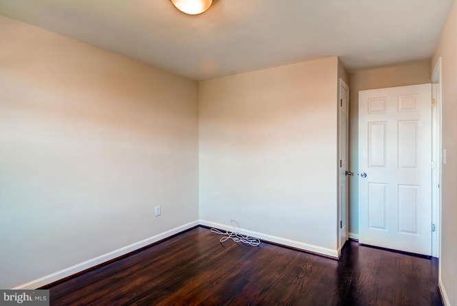 3821 Kimble Road Baltimore, MD 21218 - Photo 22 of 29 a view of an empty room with wooden floor