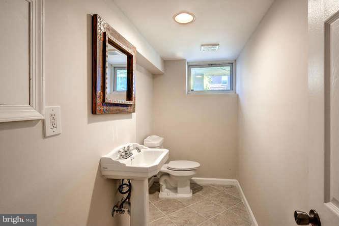 3821 Kimble Road Baltimore, MD 21218 - Photo 27 of 29 a bathroom with a sink a mirror and a toilet