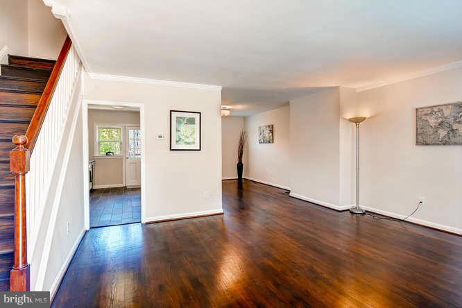3821 Kimble Road Baltimore, MD 21218 - Photo 4 of 29 an empty room with wooden floor and windows