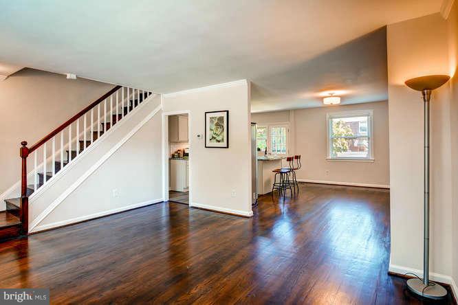 3821 Kimble Road Baltimore, MD 21218 - Photo 6 of 29 a view of a livingroom with wooden floor and a staircase