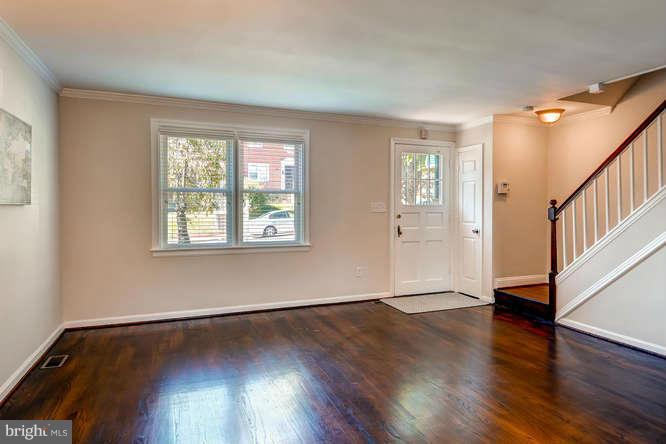 3821 Kimble Road Baltimore, MD 21218 - Photo 8 of 29 a view of an empty room with wooden floor and a window
