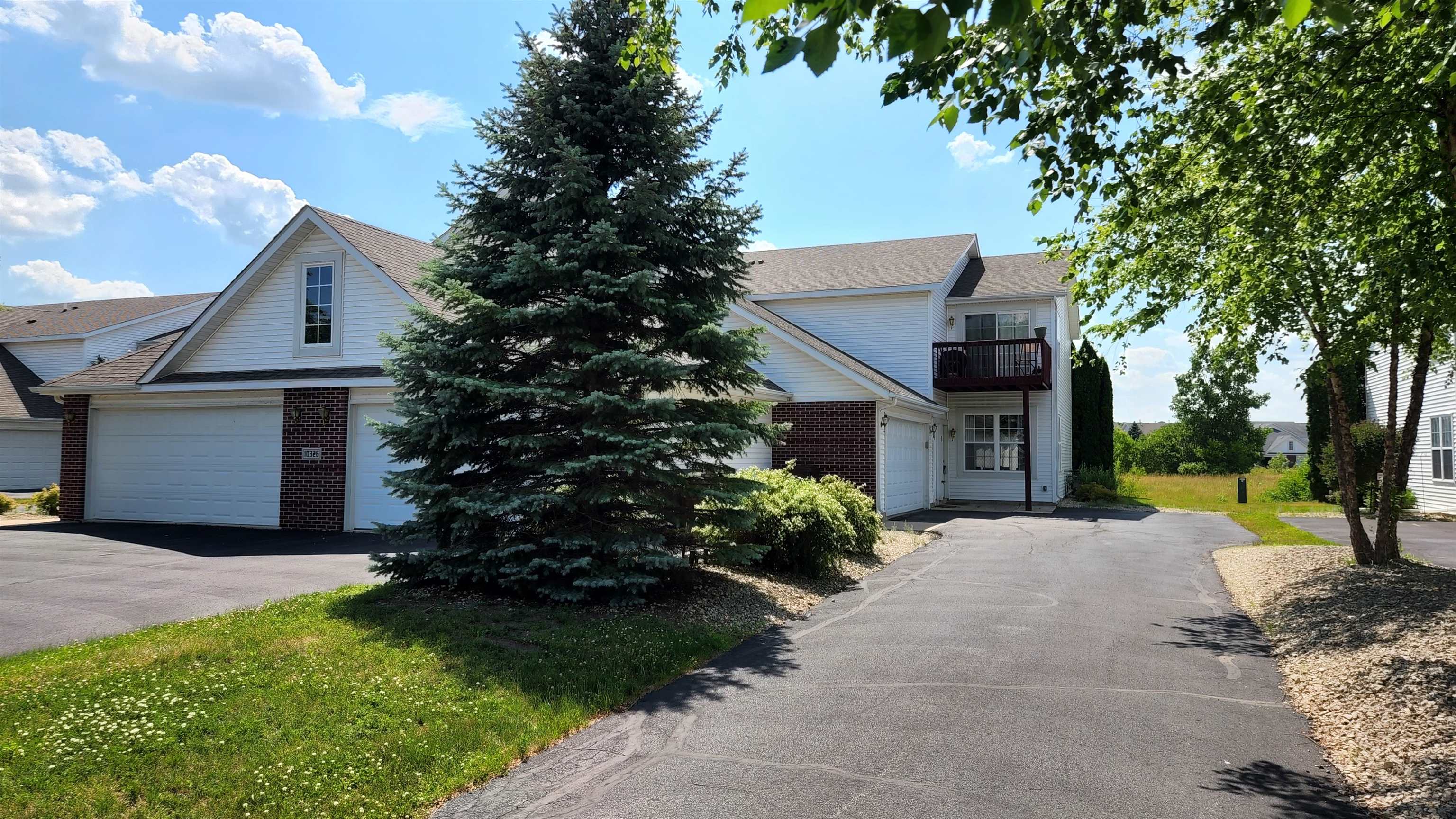 10326 Marblewing Road Roscoe, IL 61073 - Photo 1 of 12 a front view of a house with a garden and trees