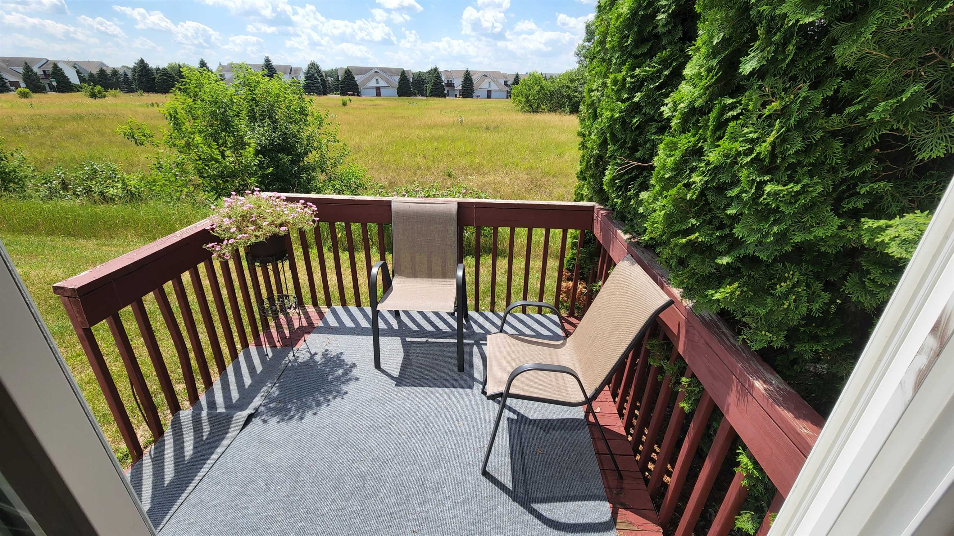 10326 Marblewing Road Roscoe, IL 61073 - Photo 11 of 12 a view of balcony with wooden floor and outdoor seating