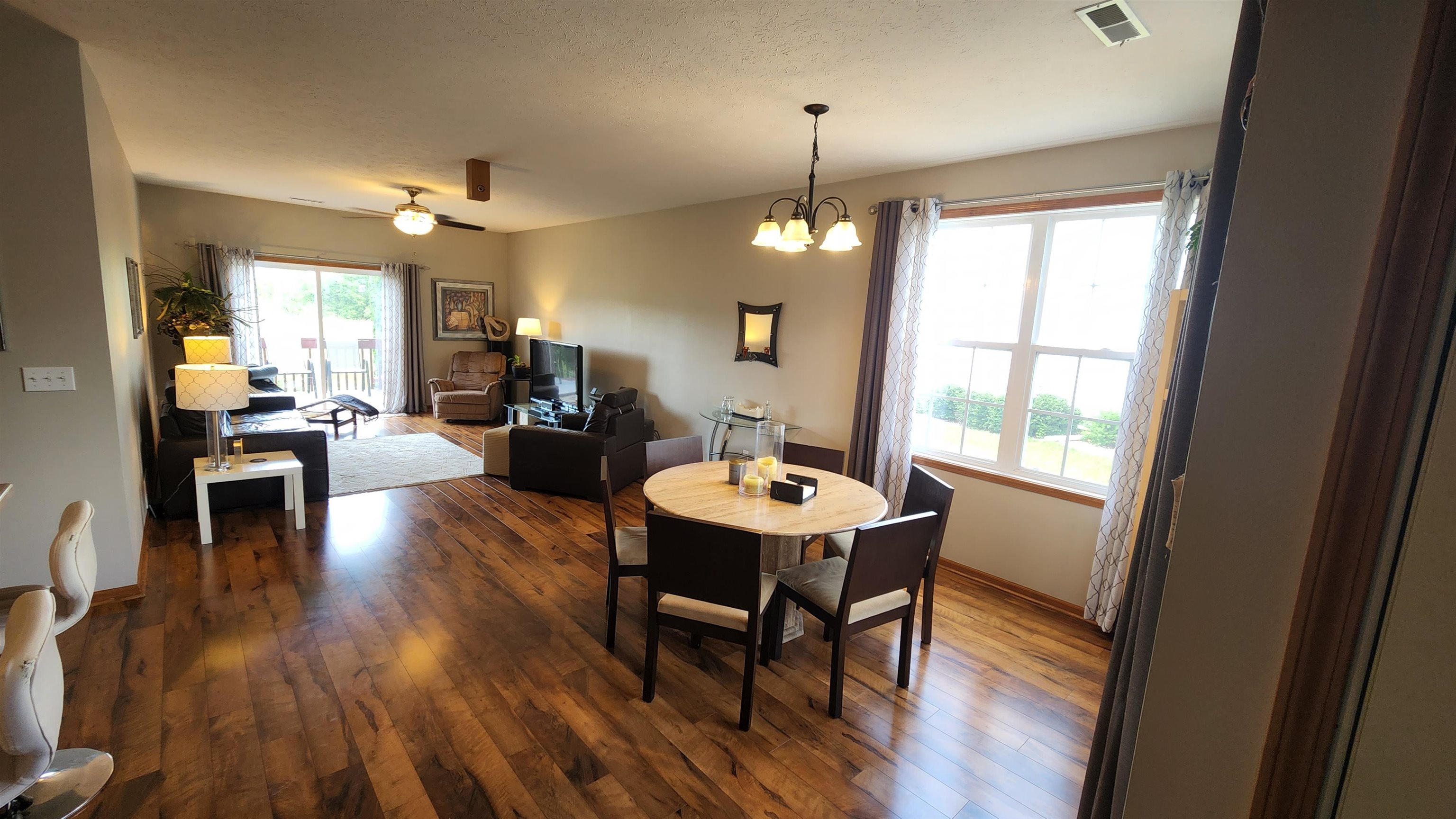 10326 Marblewing Road Roscoe, IL 61073 - Photo 2 of 12 a view of a dining room with furniture window and wooden floor
