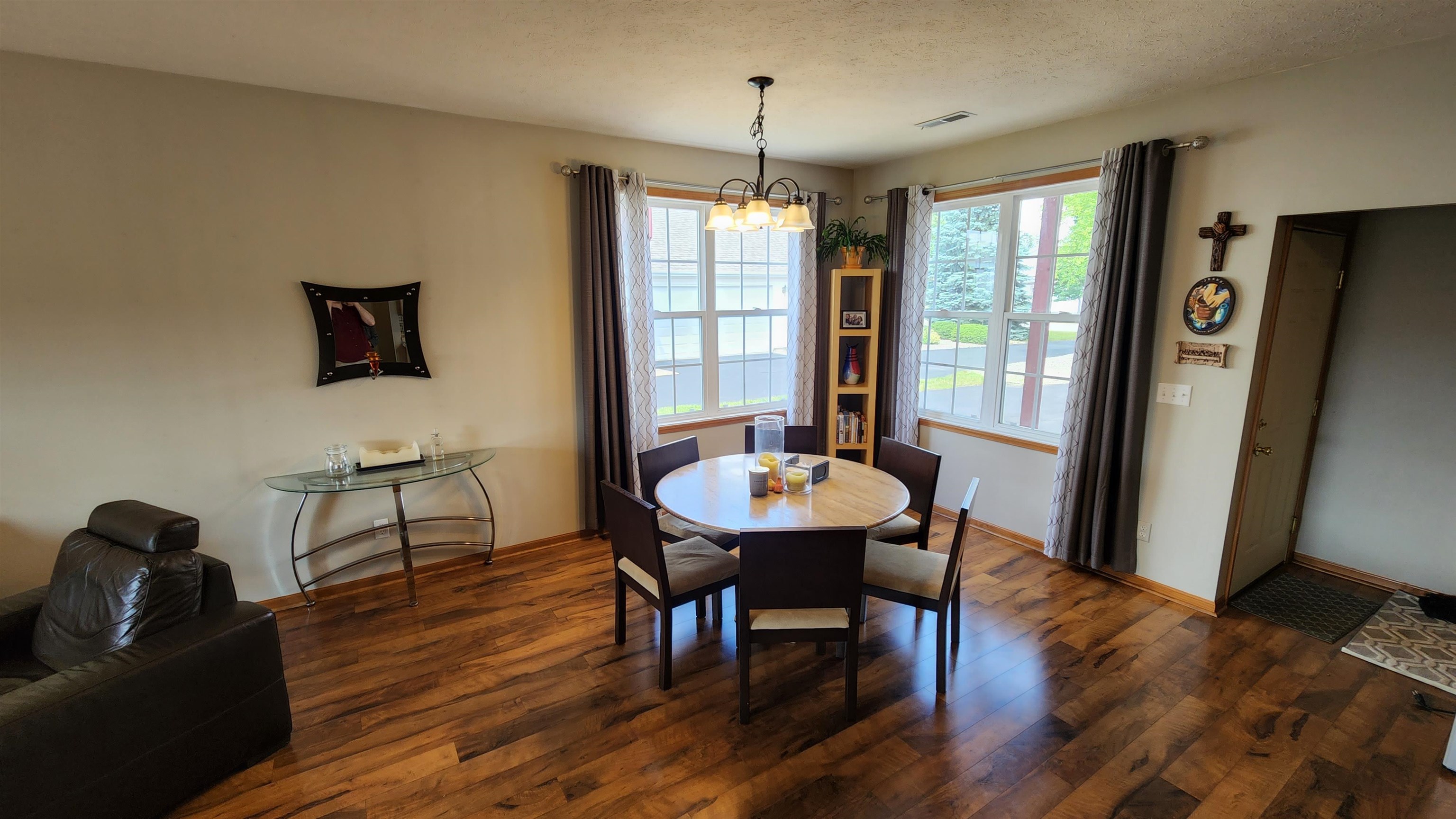 10326 Marblewing Road Roscoe, IL 61073 - Photo 3 of 12 a view of a dining room with furniture window and wooden floor