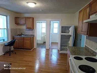 a kitchen with kitchen island stainless steel appliances a stove a sink and a refrigerator