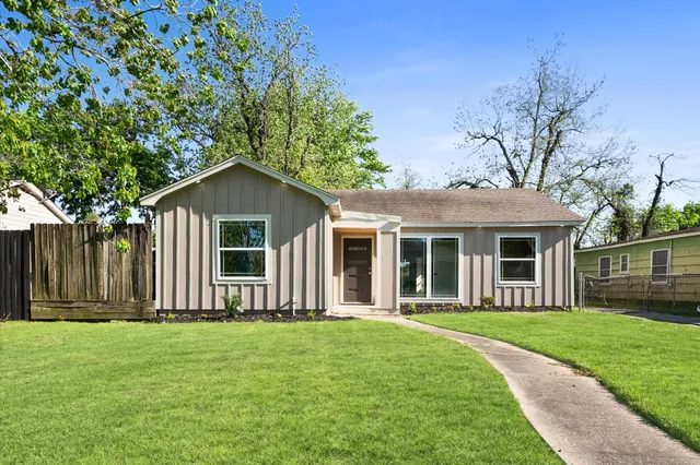 a front view of house with a garden