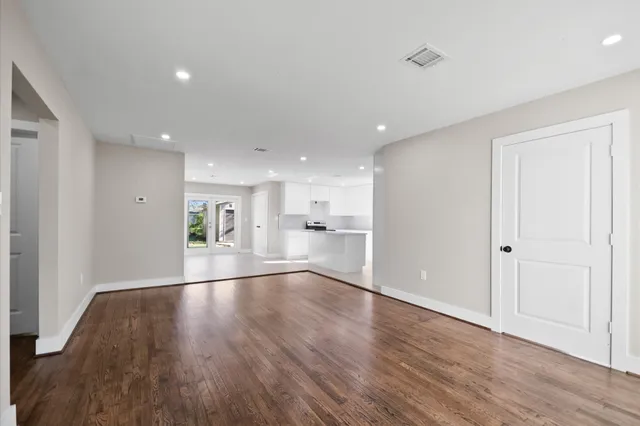 a view of an empty room and wooden floor