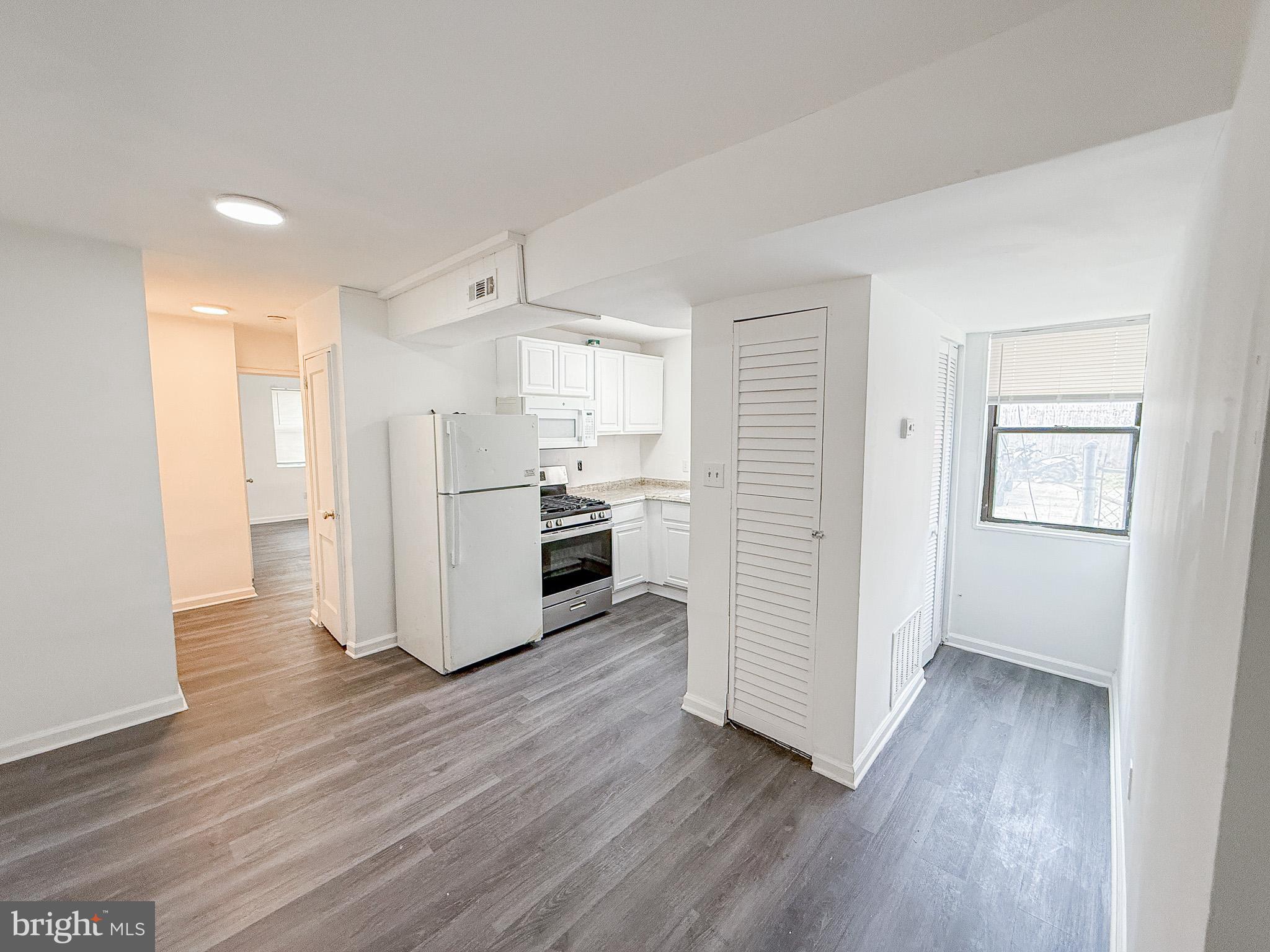 2100 Channing Street Northeast, Unit 1B Washington, DC 20018 - Photo 2 of 7 a kitchen with wooden floors and appliances