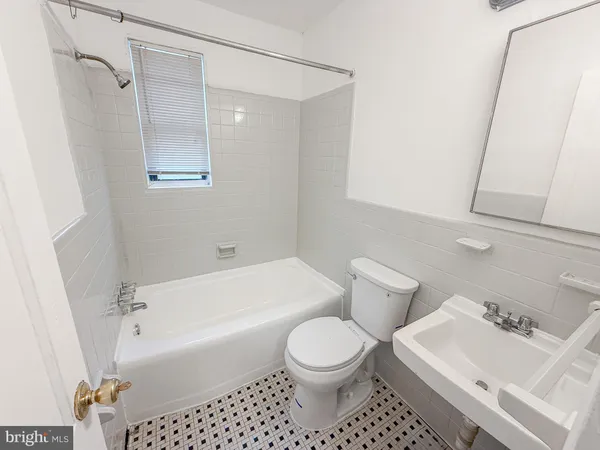 a bathroom with a toilet a sink and bathtub