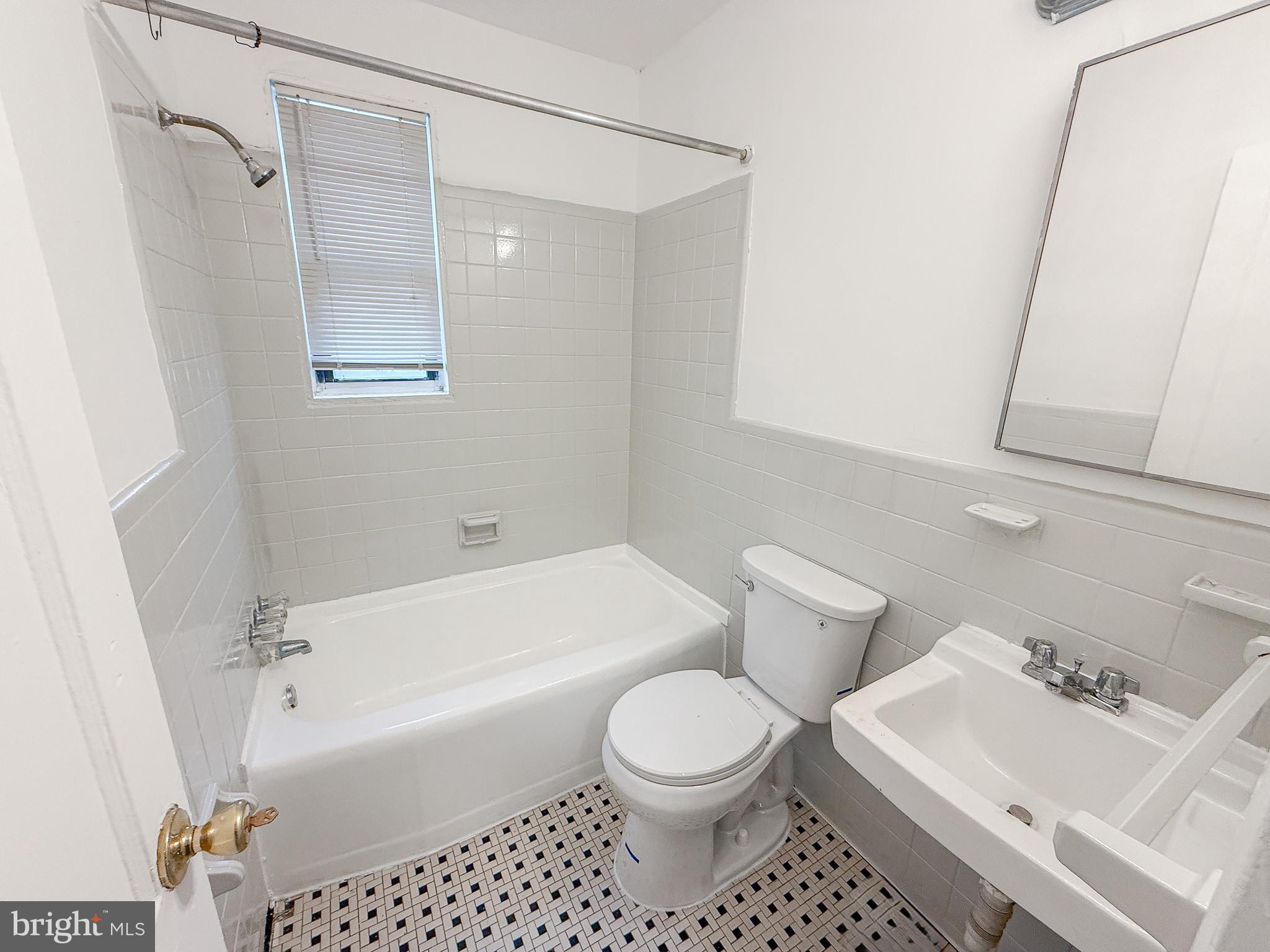 2100 Channing Street Northeast, Unit 1B Washington, DC 20018 - Photo 6 of 7 a bathroom with a toilet a sink and bathtub