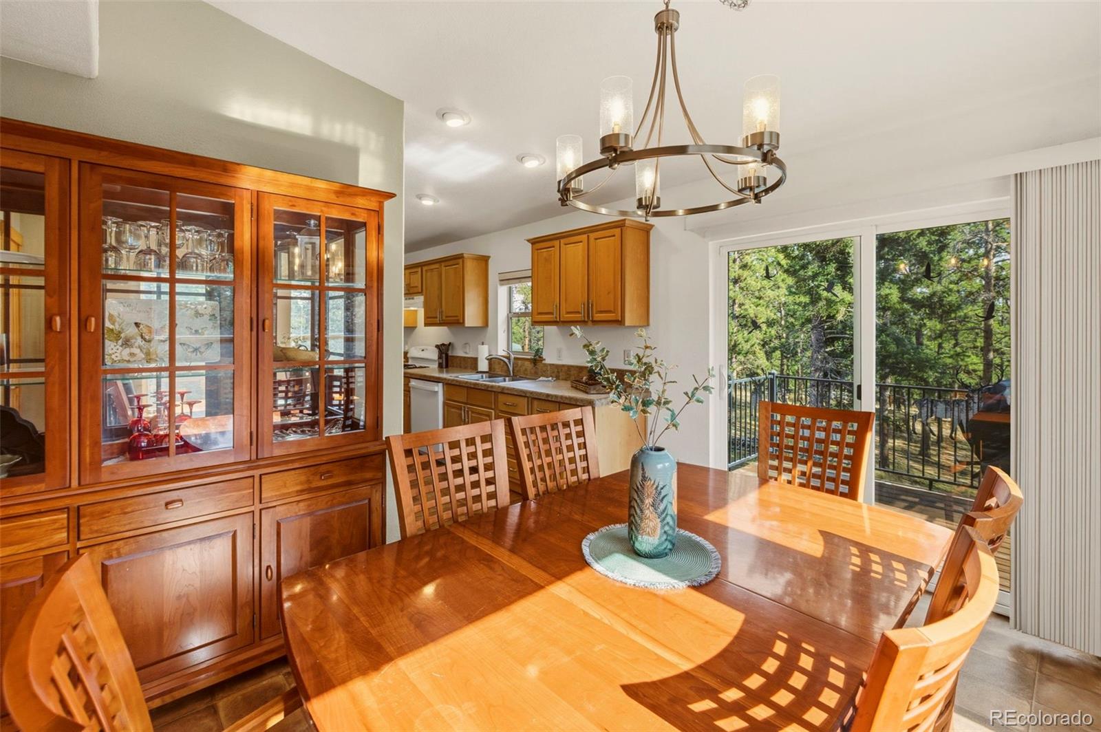 738 Rangeview Road Divide, CO 80814 - Photo 11 of 47 a view of a dining room with furniture large windows and wooden floor