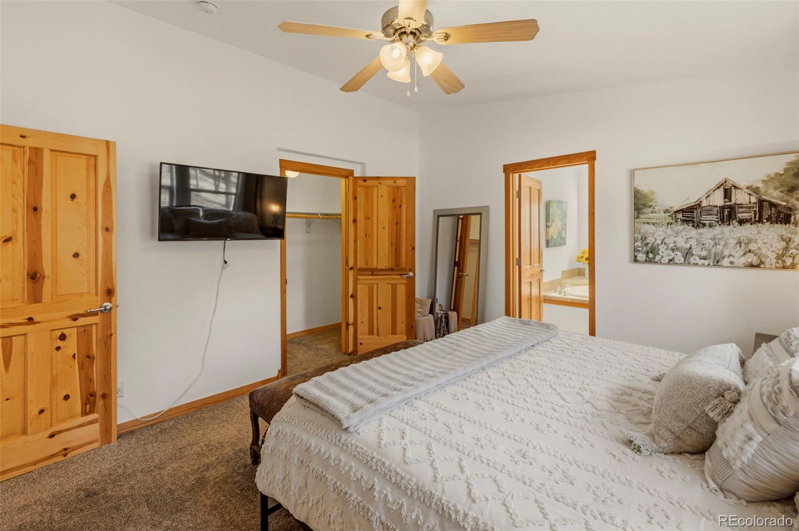 738 Rangeview Road Divide, CO 80814 - Photo 14 of 47 a bedroom with a bed and a flat screen tv