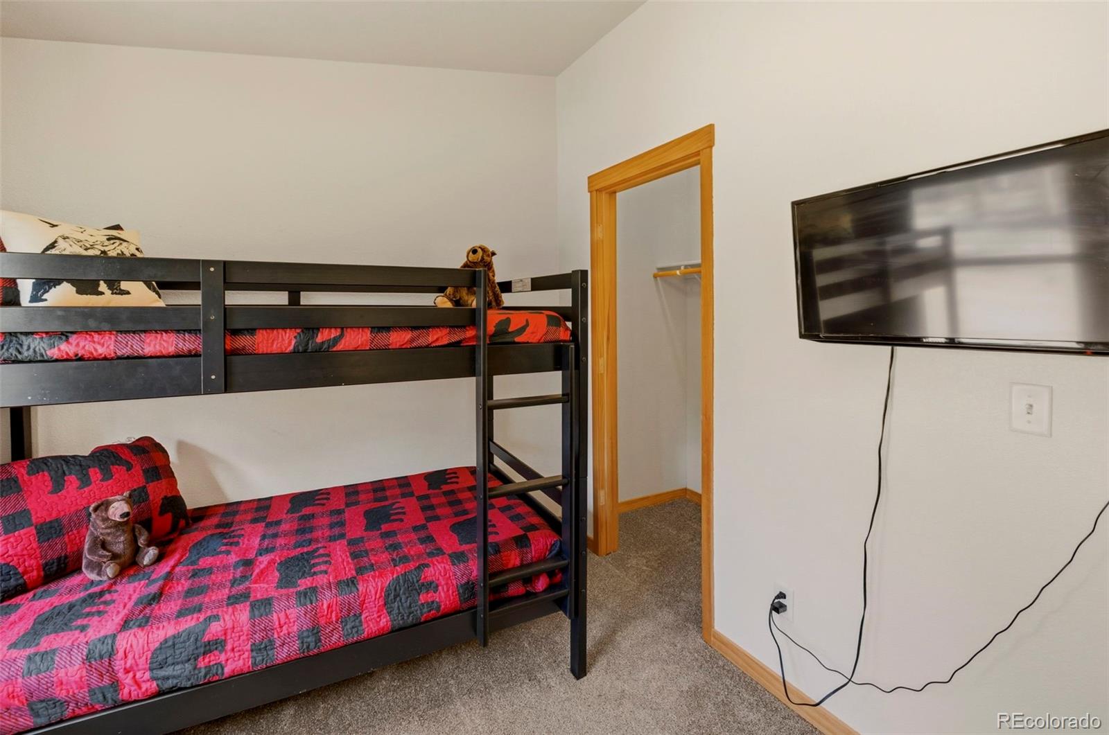 738 Rangeview Road Divide, CO 80814 - Photo 21 of 47 a bedroom with a bed and a flat screen tv
