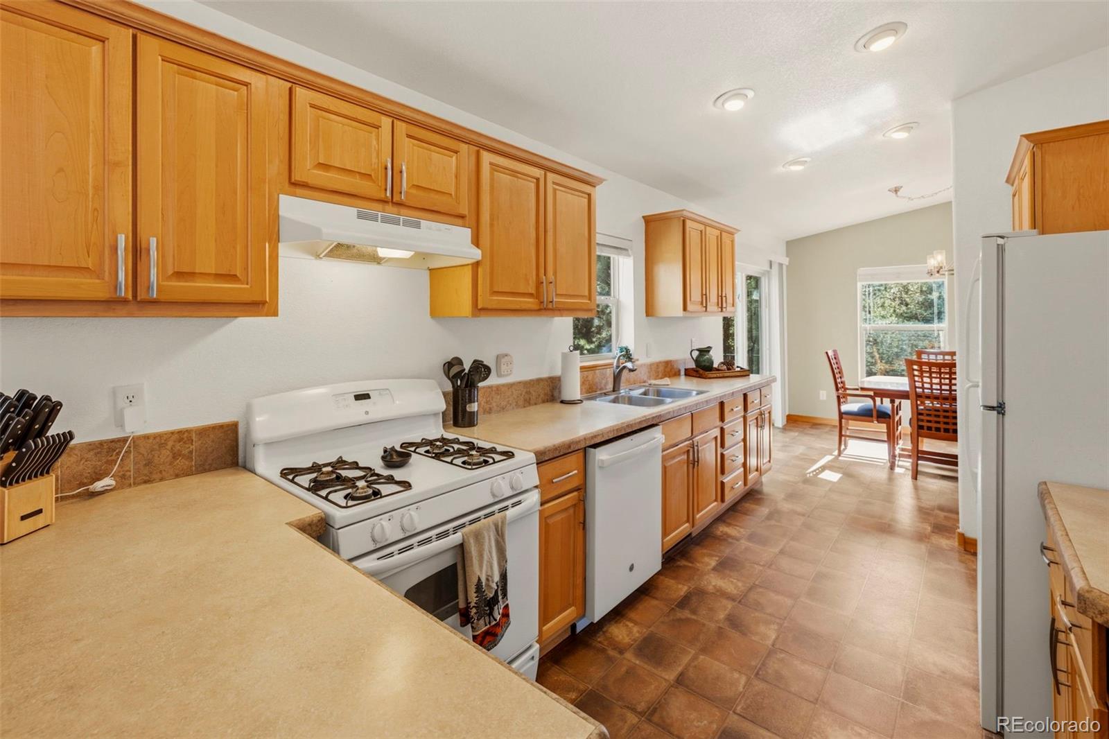 738 Rangeview Road Divide, CO 80814 - Photo 7 of 47 a kitchen with stainless steel appliances a stove a sink a refrigerator and cabinets