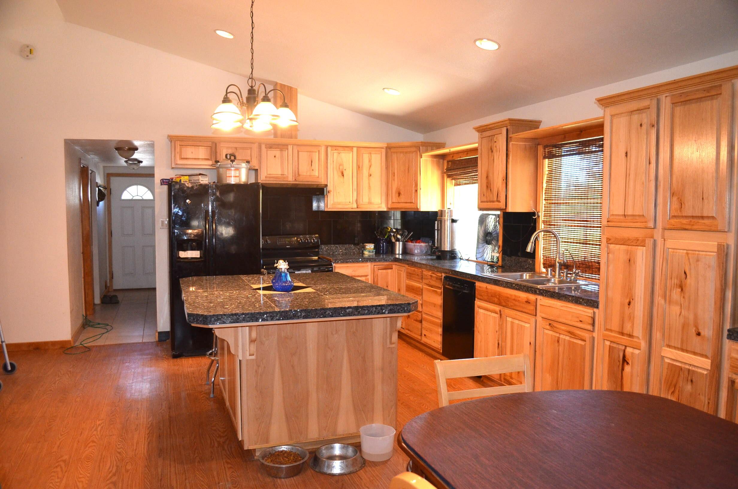 132860 Highway 97 Crescent, OR 97733 - Photo 5 of 25 a kitchen with stainless steel appliances granite countertop a sink refrigerator and cabinets