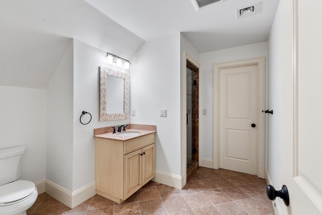 107 Kendall Road Lexington, MA 02421 - Photo 30 of 40 a bathroom with a granite countertop sink a toilet and a mirror