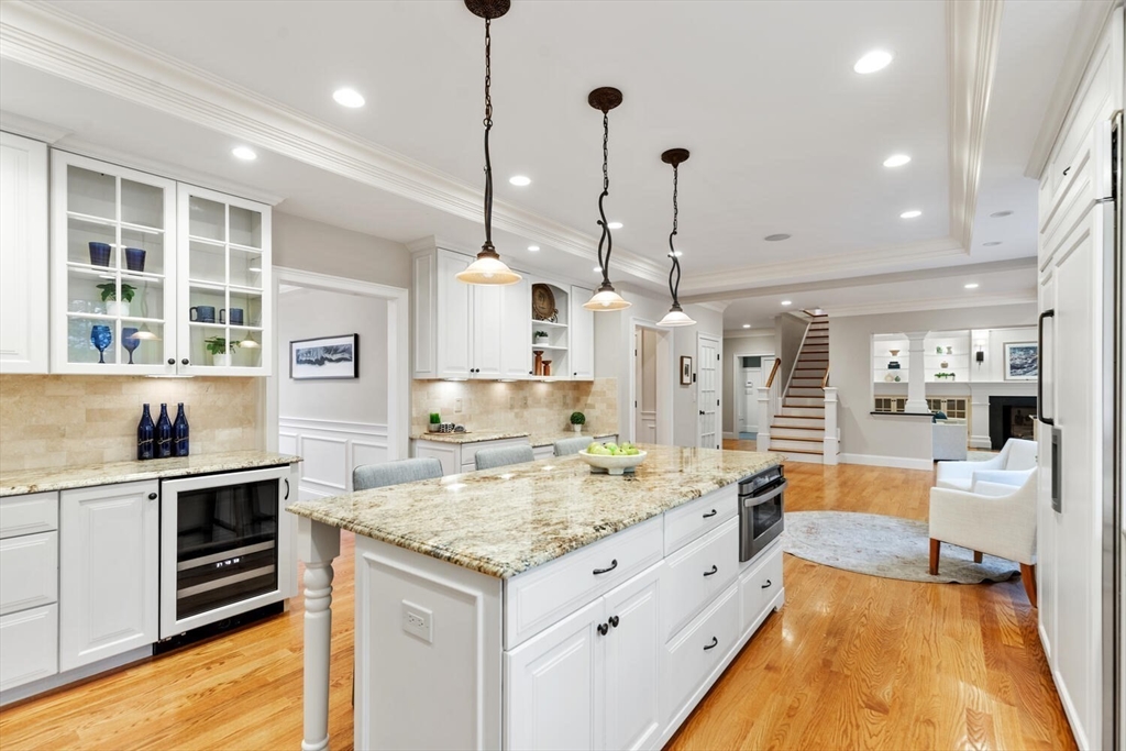 107 Kendall Road Lexington, MA 02421 - Photo 7 of 40 a large kitchen with kitchen island a stove a sink a center island and wooden floor