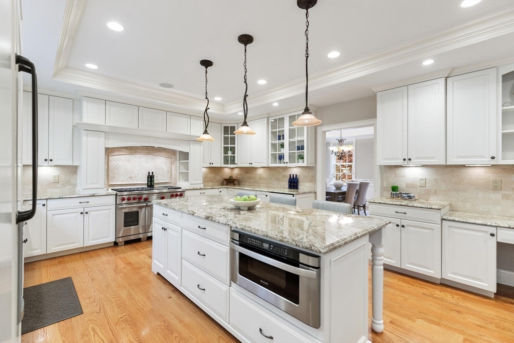 107 Kendall Road Lexington, MA 02421 - Photo 8 of 40 a kitchen with stainless steel appliances granite countertop a stove sink and cabinets