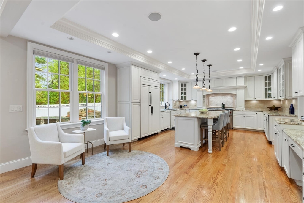 107 Kendall Road Lexington, MA 02421 - Photo 10 of 40 a living room with stainless steel appliances furniture wooden floor and a kitchen view