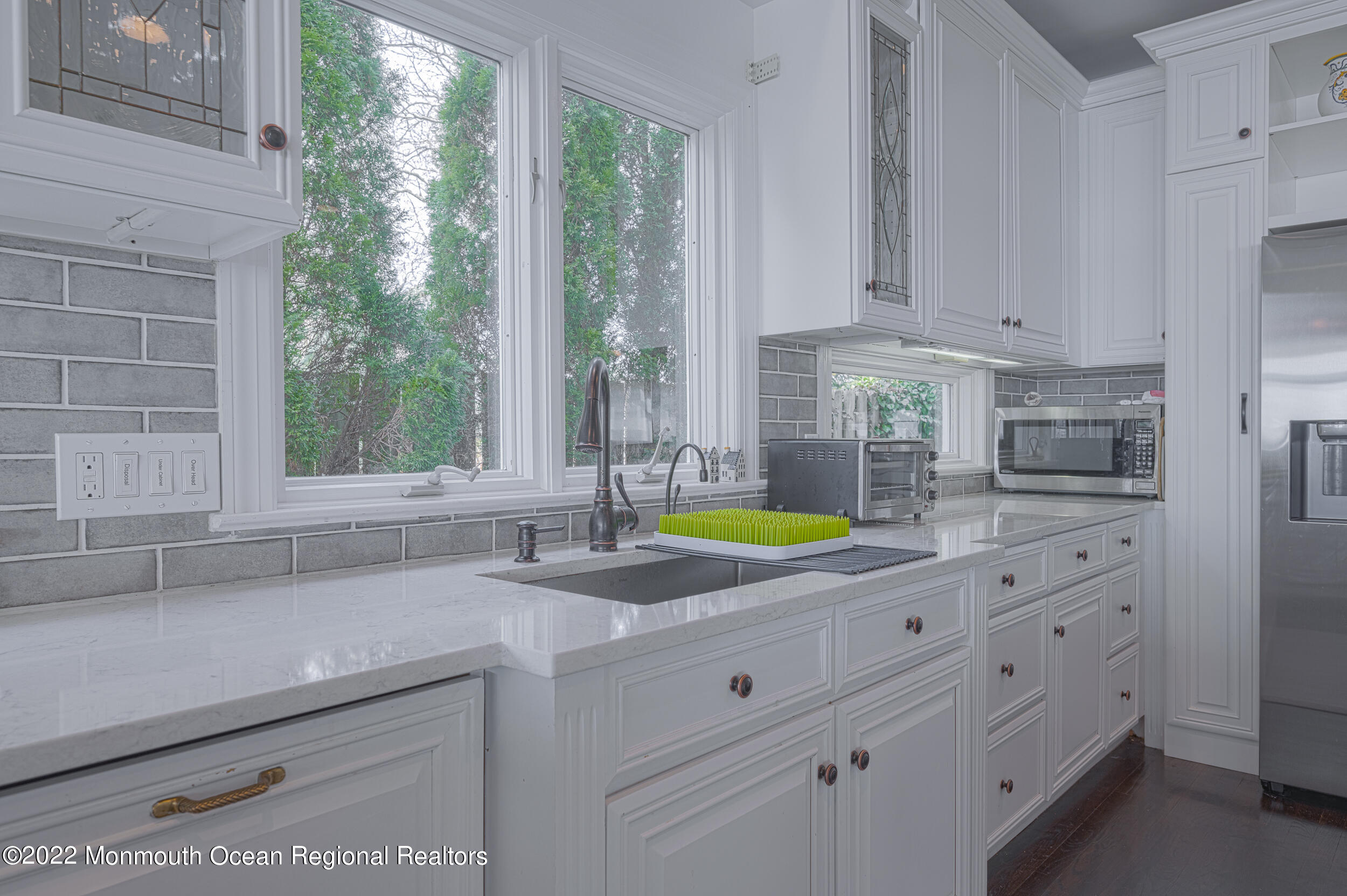 709 Princeton Avenue Brick, NJ 08724 - Photo 9 of 52 a kitchen with granite countertop a sink a counter top space and windows