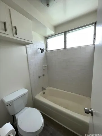 a bathroom with a toilet and a bathtub
