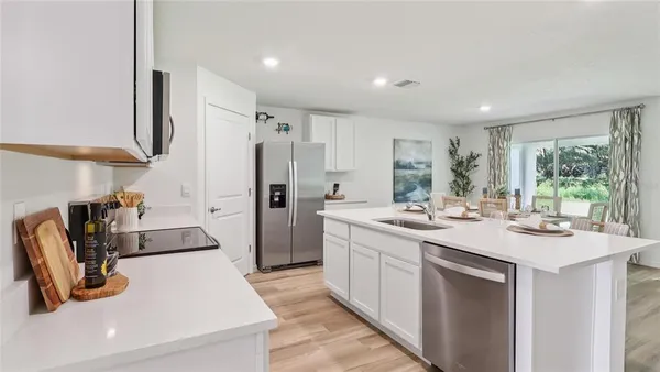 a kitchen with a sink stove and refrigerator
