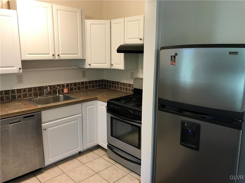 2122 Walnut Street Allentown, PA 18104 - Photo 13 of 31 a kitchen with a stove and white cabinets