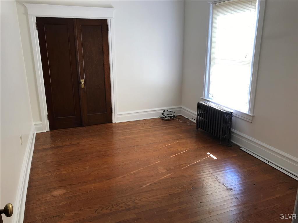 2122 Walnut Street Allentown, PA 18104 - Photo 15 of 31 an empty room with wooden floor and window