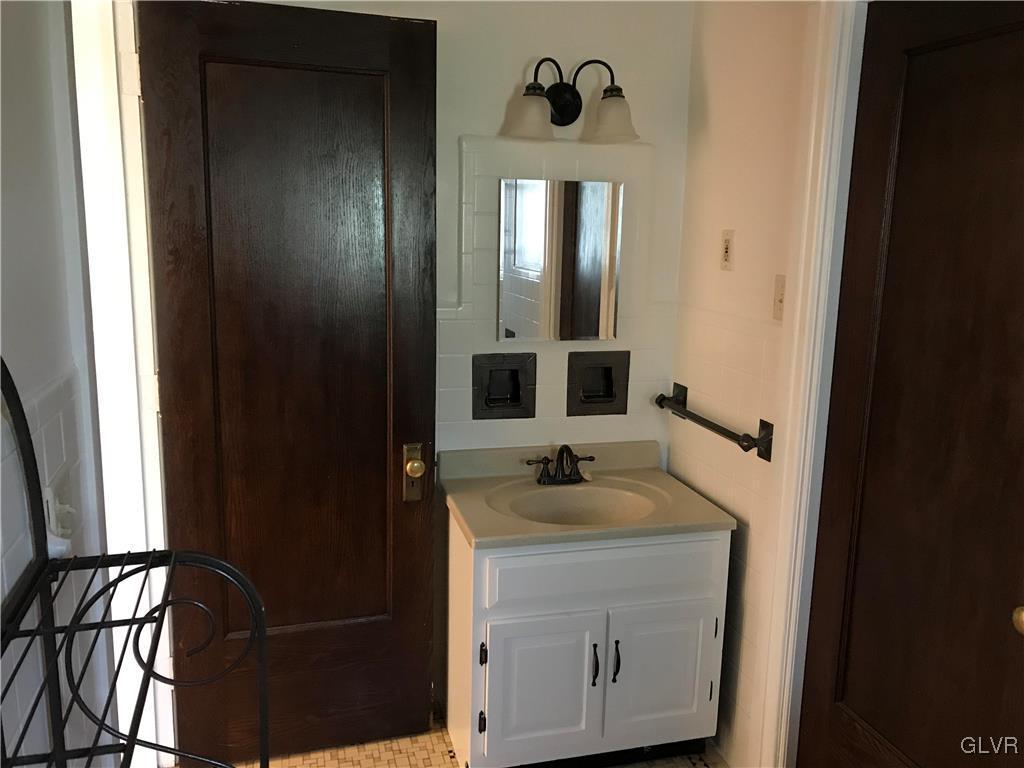 2122 Walnut Street Allentown, PA 18104 - Photo 22 of 31 a bathroom with a sink and a mirror