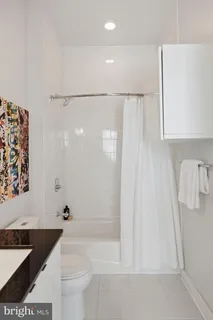 a bathroom with a shower curtain and a toilet