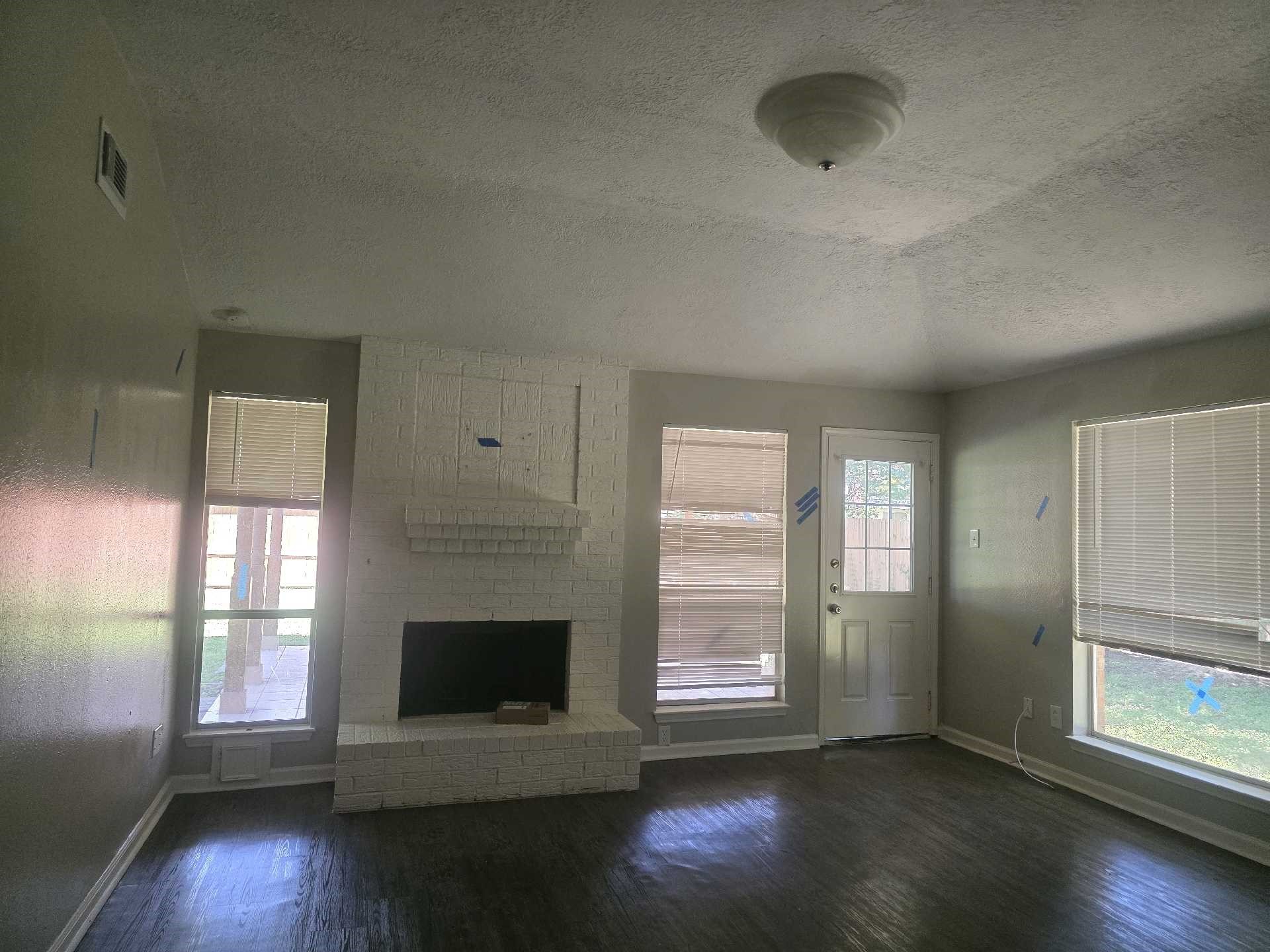 5006 Timber Ridge Street Baytown, TX 77521 - Photo 6 of 6 an empty room with wooden floor and windows