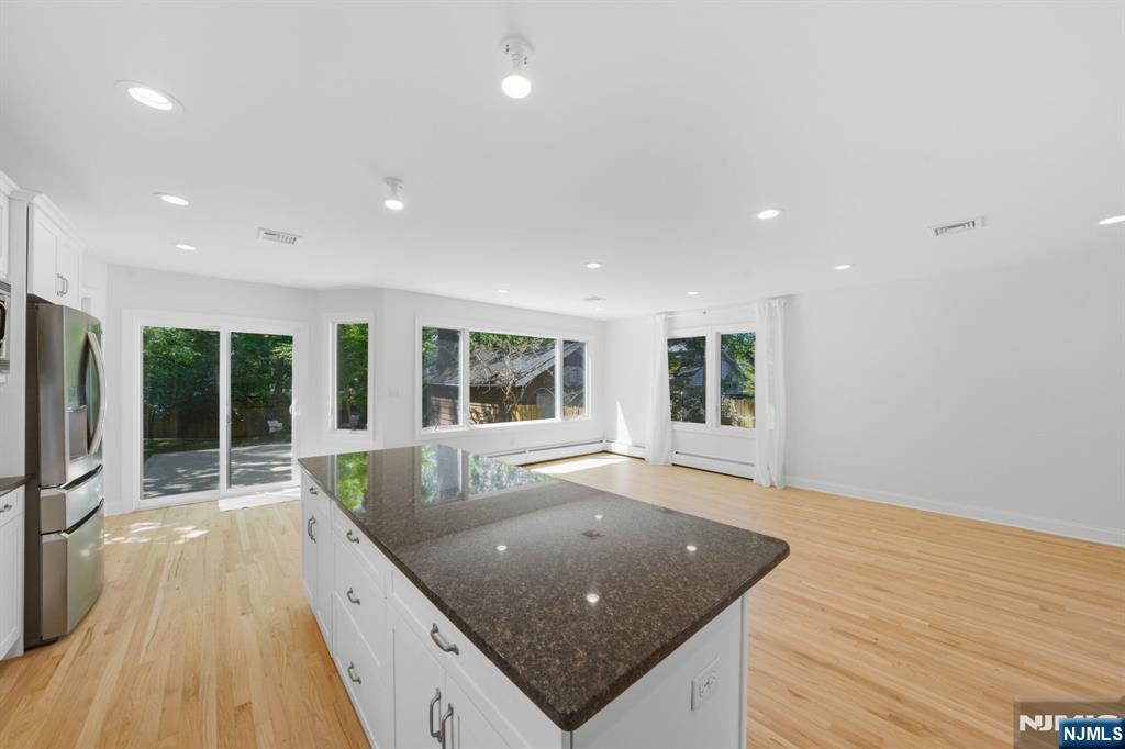 232 Riveredge Road Tenafly, NJ 07670 - Photo 17 of 50 a living room with stainless steel appliances granite countertop furniture wooden floor and a large window